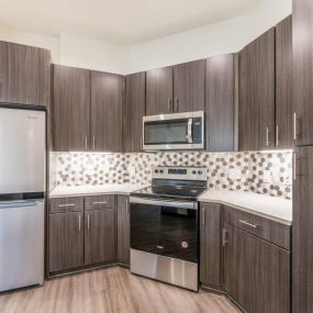 Kitchen with dark wood cabinets and white countertops