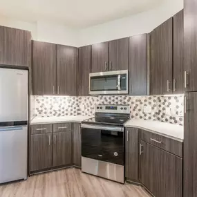 Kitchen with dark wood cabinets and white countertops