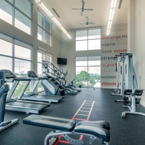 The gym with treadmills and other exercise equipment