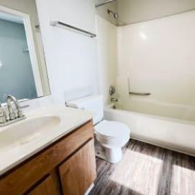 an empty bathroom with a sink toilet and bathtub