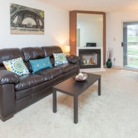 a living room with a leather couch and coffee table