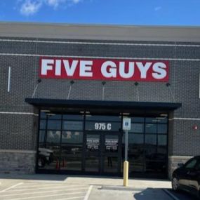 Exterior photograph of the Five Guys restaurant at 975 South Amity Road in Conway, Arkansas.