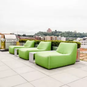 Green lounge chairs at Icon's rooftop deck