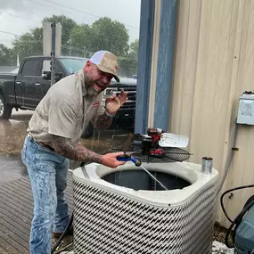 Owner Patrick Bentley working alongside our techs in the rain on a field day