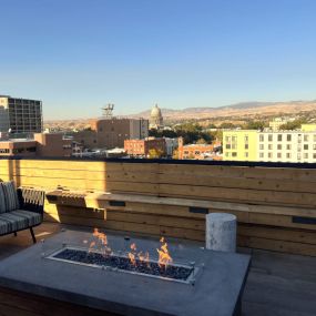 Rooftop patio lounge with a fire pit overlooking downtown Boise