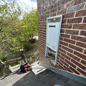 navien external tankless water heater installed on roof