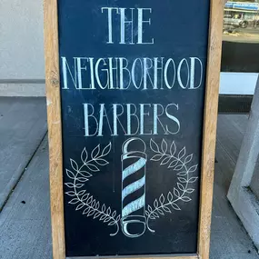 The Neighborhood Barbers sign at the front entrance