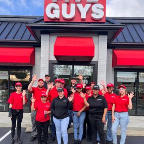 Employees pose for a photograph outside the entrance to the Five Guys restaurant at 101 Lawson Drive in Georgetown, Kentucky.