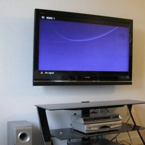 Mounted tv above home entertainment center