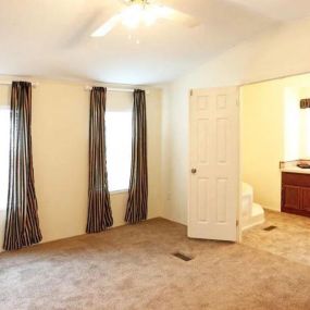 a living room with a white door and a white chair