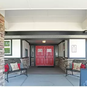 a red door on a building with a porch