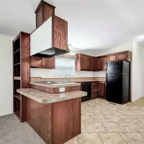 kitchen with wooden cabinets and a black refrigerator