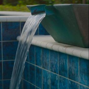 Fountain with waterfall by pool