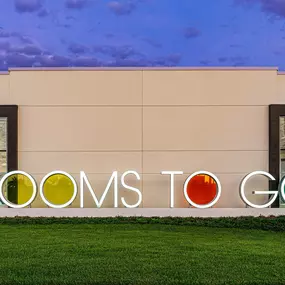 Iconic Rooms To Go logo with illuminated signage.