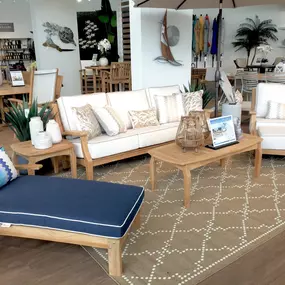 Classic teak outdoor lounge set with navy and white cushions and a relaxing coastal theme.