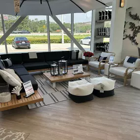 Sleek black and natural wood outdoor sectional with modern décor and neutral seating.