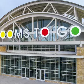 Close-up view of the Rooms To Go store facade in The Colony, Texas.