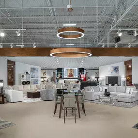 Elegant showroom display with neutral-toned furniture and lighting.