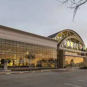 Sunset exterior view of the Rooms To Go store in The Colony, Texas.