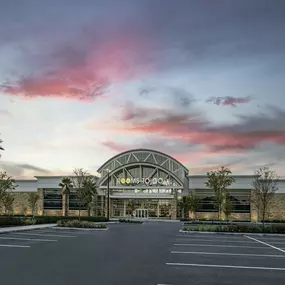 Stunning Rooms To Go exterior with a vibrant sunset sky.