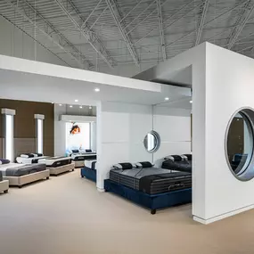 Modern mattress showroom at Rooms To Go Pearland, TX, featuring premium beds and sleek decor.