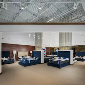 Modern mattress showroom with premium beds and elegant design.