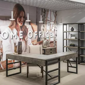 Modern home office setup with industrial-style furniture in a showroom.