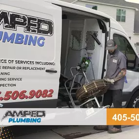 Unloading a drain cleaning machine at a customer house in Oklahoma City