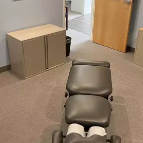 chiropractic adjustment table in a private treatment room