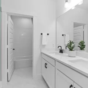 Secondary bathroom with double vanity in Legacy at Lake Dunlap by Pulte Homes.