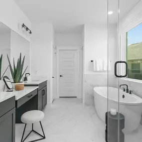 Freestanding tub and glass wall shower at owner's bath in Legacy at Lake Dunlap by Pulte Homes.