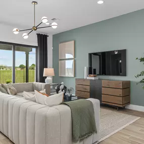 Spacious living room with sliding glass doors in Legacy at Lake Dunlap by Pulte Homes.