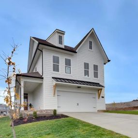 a cozy white new construction home with green grass