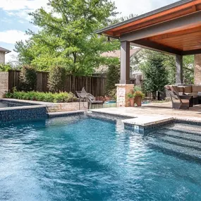 Pool, spa, waterfall, and patio cover