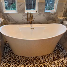 New stand alone tub, with gold trim finishes.