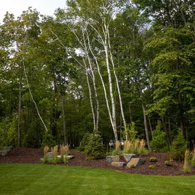 This recent project was one of our favorite ones yet. We kept the roadside landscaping minimalistic, yet polished, with the mature trees framing this incredible lake home. With the addition of fresh mulch, shrubbery, and decorative rock, the roadside landscaping makes a great first impression.