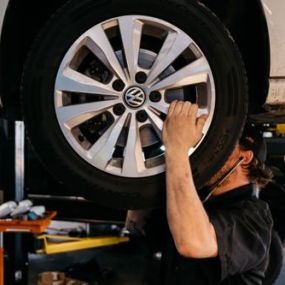 car mechanic checking wheel