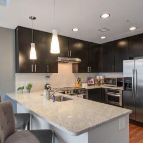 Spacious kitchen with stainless steel appliances and kitchen island.