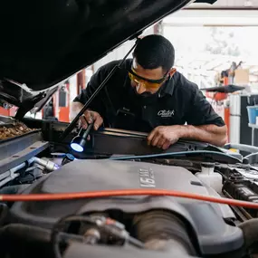 car mechanic checking the car's hood