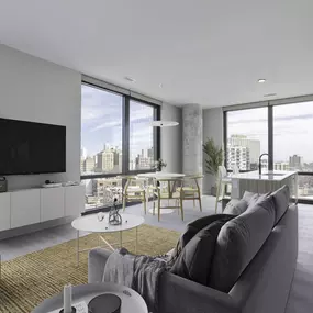 a living room with a gray couch and a yellow rug