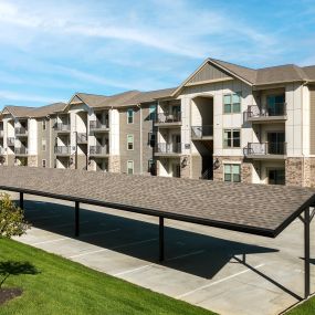 an overhead view of an apartment building with a parking lot