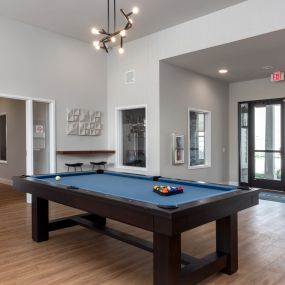 a pool table in the clubhouse of a new home