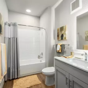 a bathroom with a shower toilet and sink