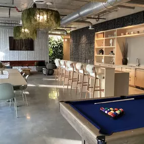 Lounge room with pool table and kitchen