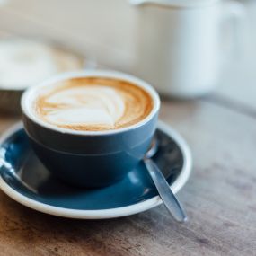 a cup of coffee on a plate on a table