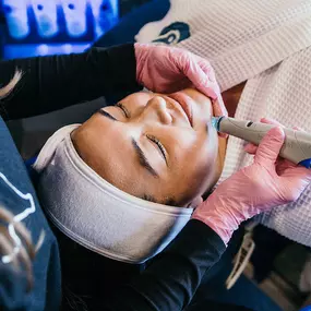 A woman receiving a Hydrafacial treatment