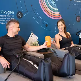 A man and woman enjoying leg compression.