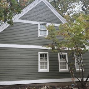 Dark green siding with cedar shake and traditional board.