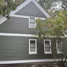 Dark green siding with cedar shake and traditional board.