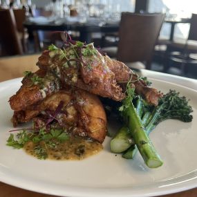 Roasted Chicken served with smashed marbled potato, grilled broccolini and citrus herb jus.